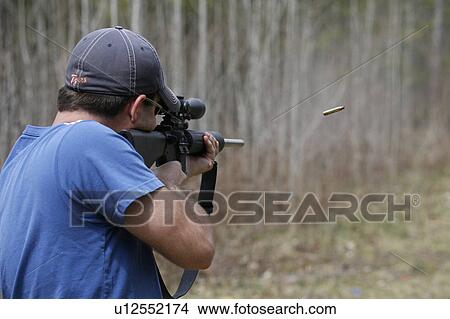 Picture - man male shooting rifle aiming case . Fotosearch