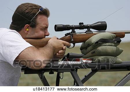 Stock Photo -  man shooting bolt action rifle bench . Fotosearch