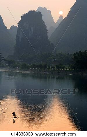man sun male paddles bamboo raft lijiang river View Large Photo Image Stock Image - man sun male paddles bamboo raft lijiang river . Fotosearch