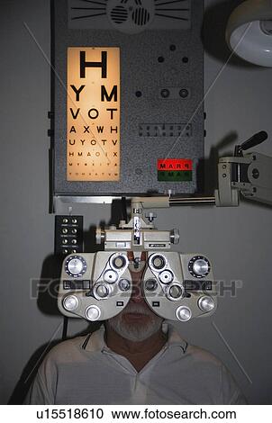 Stock Image -  medical man patient undergoing eye test use exam . Fotosearch