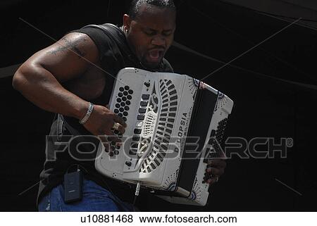 Stock Photo -  music art zydeco musician rocks out accordion. Fotosearch