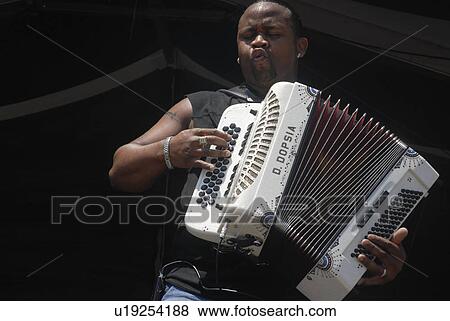 Stock Photo -  music art zydeco musician rocks out accordion. Fotosearch