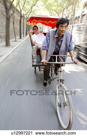 Stock Image -  pedicab driver gives tourist rickshaw ride china. Fotosearch
