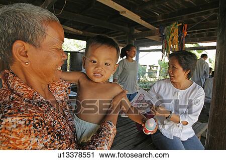 Stock Image -  people child person children cambodia feeding . Fotosearch