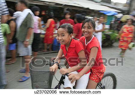 Stock Photograph -  people child person children girls bicycle scene . Fotosearch