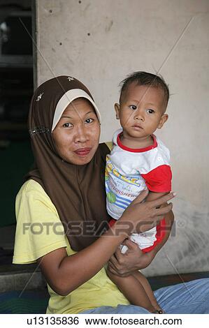 Stock Photograph -  people child person indonesia mother living aceh . Fotosearch