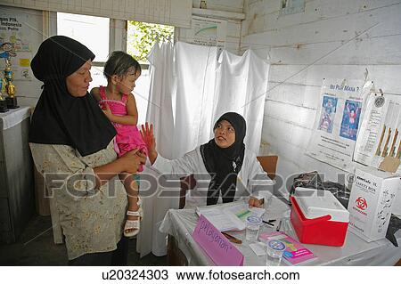 Stock Image -  people child person indonesia nurse examining . Fotosearch