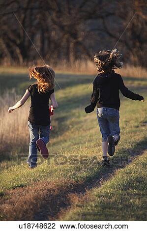 people children two girls running causeway View Large Photo Image Stock Image - people children two girls running causeway . Fotosearch
