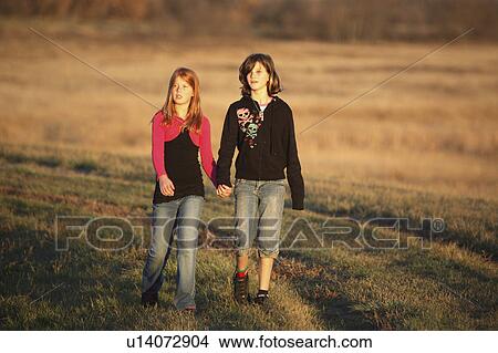 people children two girls walking causeway View Large Photo Image Picture - people children two girls walking causeway . Fotosearch