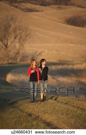 Stock Image -  people children two girls walking causeway . Fotosearch
