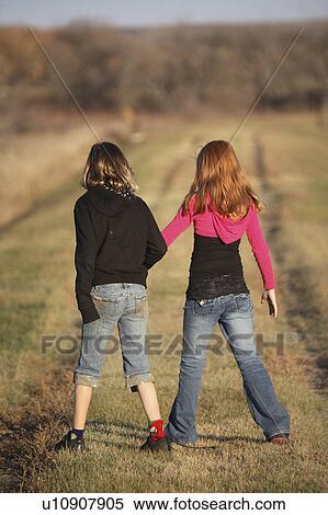 Stock Photography -  people children two girls walking causeway . Fotosearch