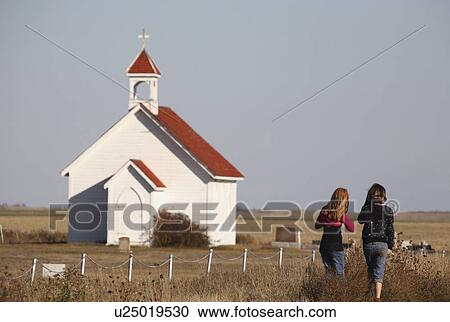 Stock Image -  people children young girls walking saint church. Fotosearch
