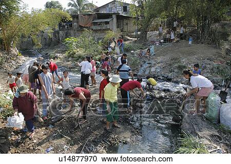 Stock Image -  people person cleaning up filthy polluted stream . Fotosearch