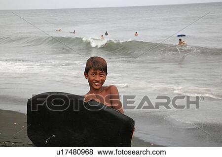 Stock Photo -  people person indonesia balinese boy surfing . Fotosearch