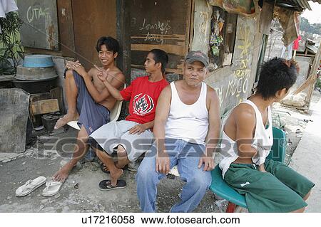 Stock Photo -  people person men hanging out street scene slum . Fotosearch
