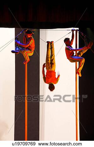 Stock Photo -  pole climbers in chinese acrobatic show beijing. Fotosearch