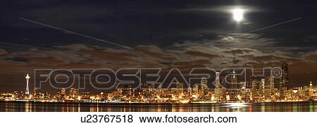 Stock Photo -  seattle skyline space needle full moon in elliot. Fotosearch