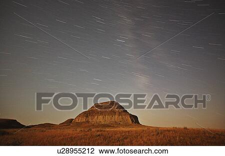Stock Image -  star moon lit castle butte tracks in scenic star . Fotosearch