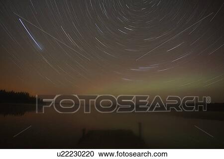 Stock Image -  star northern nights trails in scenic landscape. Fotosearch