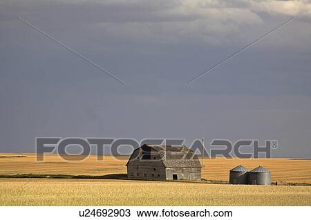 summer stom clouds behind some farm buildings View Large Photo Image Stock Image - summer stom clouds behind some farm buildings . Fotosearch