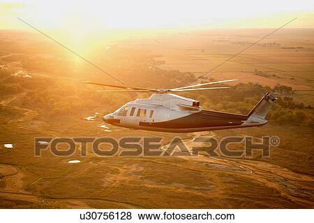 Stock Photo -  sun aerial view aircraft aviation chopper copter. Fotosearch