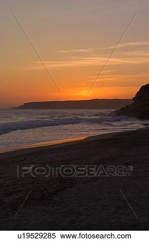 Stock Photography -  sunset ocean color cliffs in small town salema. Fotosearch