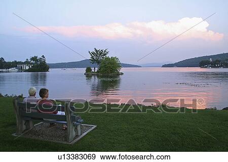 Stock Photo -  sunset over meredith bay new hampshire lake hall. Fotosearch
