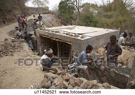 Stock Image -  timor leste villagers labor build new road. Fotosearch