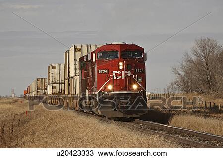 Stock Image -  train carrying containers railway tracks red . Fotosearch