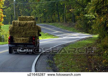Stock Photo -  truck overloaded hay over filled stacked stack. Fotosearch