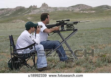 Stock Photo -  two man varmint hunting team hunters . Fotosearch