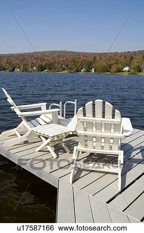 Stock Photograph -  water home relaxing chairs in beautiful setting. Fotosearch