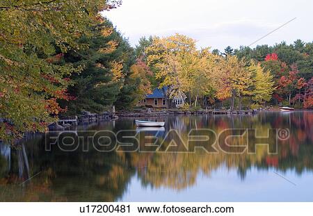Stock Image -  water peaceful quiet scene lake small boat . Fotosearch