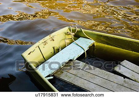 Stock Image -  water swamped boat amsterdam canal . Fotosearch