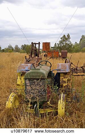 Stock Photo -  water vintage old tractor machinery abandoned in. Fotosearch