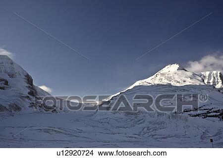 Picture -  winter rocky mountains in snow covered shadows. Fotosearch