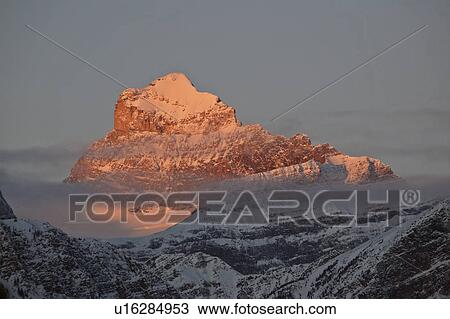 winter sun rocky mountains in snow covered haze View Large Photo Image Stock Image - winter sun rocky mountains in snow covered haze. Fotosearch