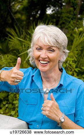 woman attractive colorful in 60s smiling happy View Large Photo Image Stock Photo - woman attractive colorful in 60s smiling happy . Fotosearch
