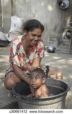 Stock Image -  woman baby people child children timor leste . Fotosearch