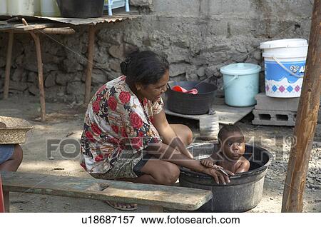 Stock Photo -  woman baby people child children timor leste for internally displaced. Fotosearch