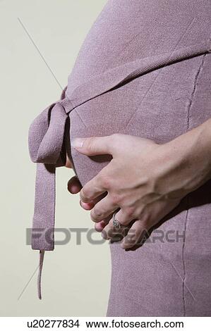Picture -  woman baby pregnant belly belgium expecting woman . Fotosearch