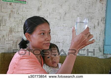 Picture -  woman baby water people person women indonesia . Fotosearch