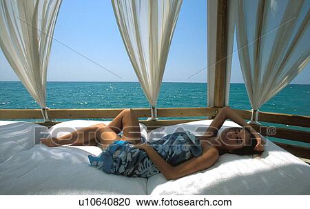 Stock Image -  woman beach 25-30 years brunette cabana comfort. Fotosearch
