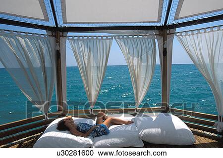 Stock Image -  woman beach person 25-30 years brunette cabana. Fotosearch