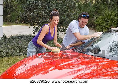 Stock Image -  woman car couple man affluent young in 30s fun. Fotosearch
