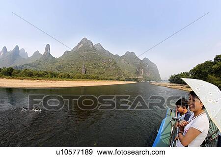 woman child kid female boy cruising lijiang asia View Large Photo Image Stock Photo - woman child kid female boy cruising lijiang asia . Fotosearch