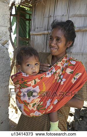 Stock Image -  woman child kid women timor leste mother village. Fotosearch