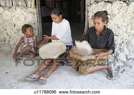 Stock Photograph -  woman food child children women timor leste rice. Fotosearch