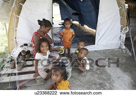 Stock Image -  woman food people child children timor leste. Fotosearch