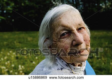 Stock Photo -  woman sun beauty louise britt sits outdoors goes. Fotosearch